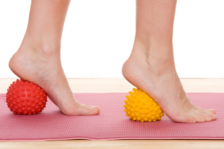 Feet on arch rolling balls to prevent arches hurting